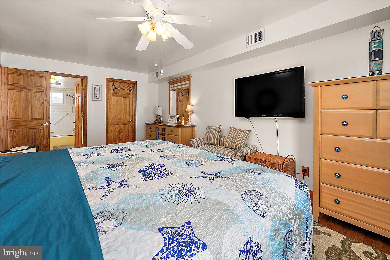 11602 Coastal Highway, Unit 1A Ocean City, MD 21842 - Photo 28 of 83 a bedroom with a bed and a flat screen tv