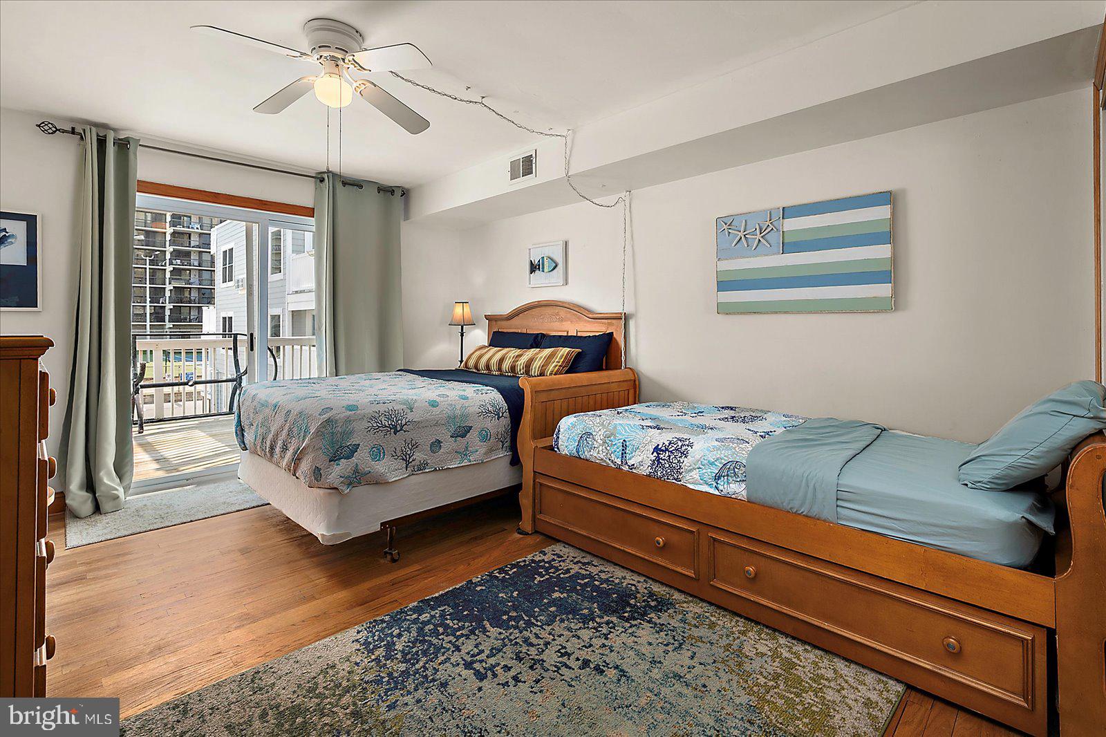 11602 Coastal Highway, Unit 1A Ocean City, MD 21842 - Photo 30 of 83 a bedroom with a bed and wooden floor