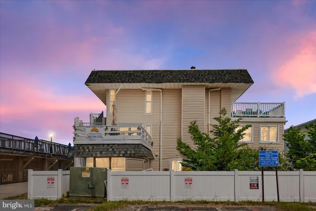 a front view of a house with a street