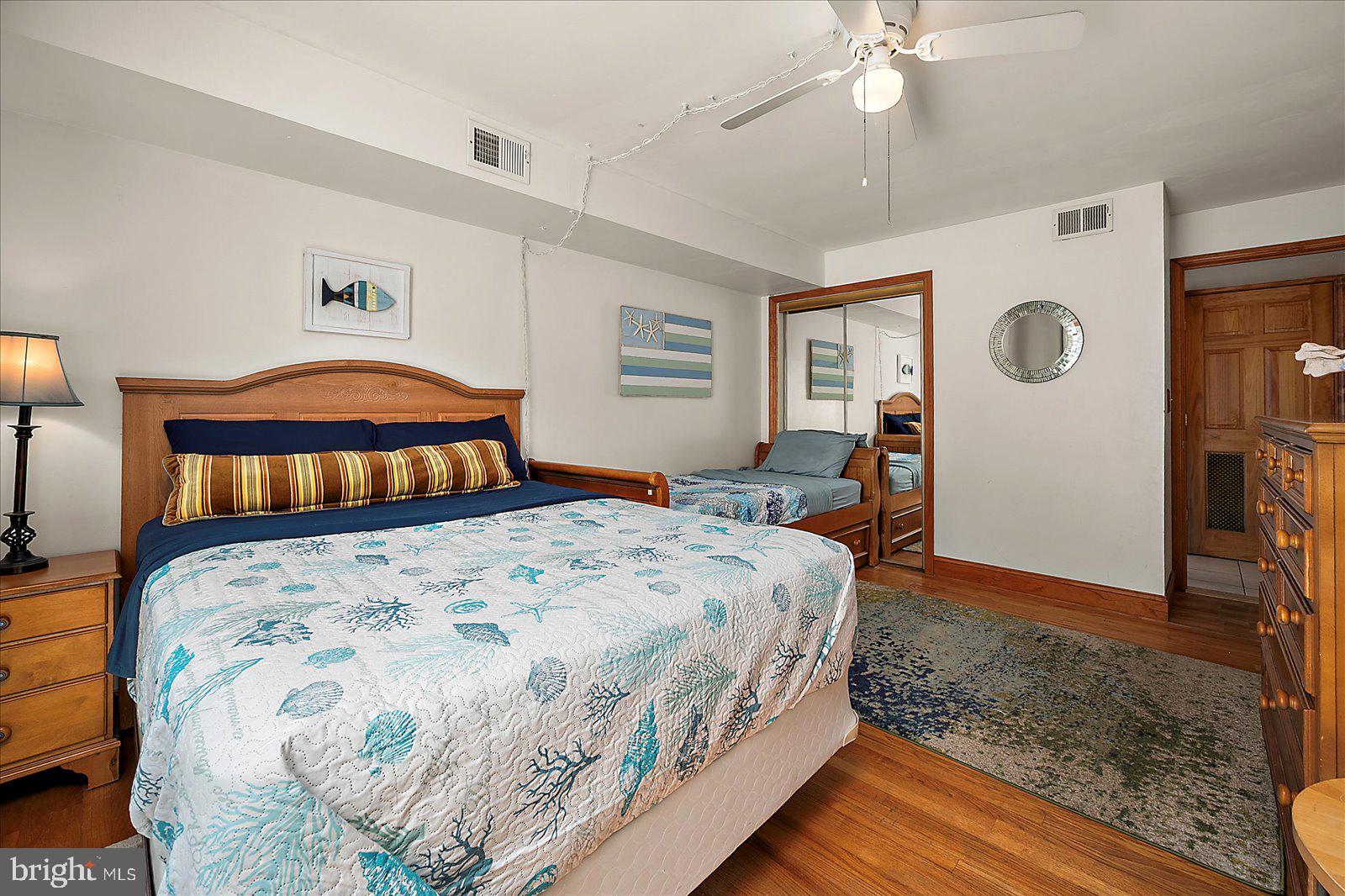 11602 Coastal Highway, Unit 1A Ocean City, MD 21842 - Photo 32 of 83 a bedroom with a bed and a dresser