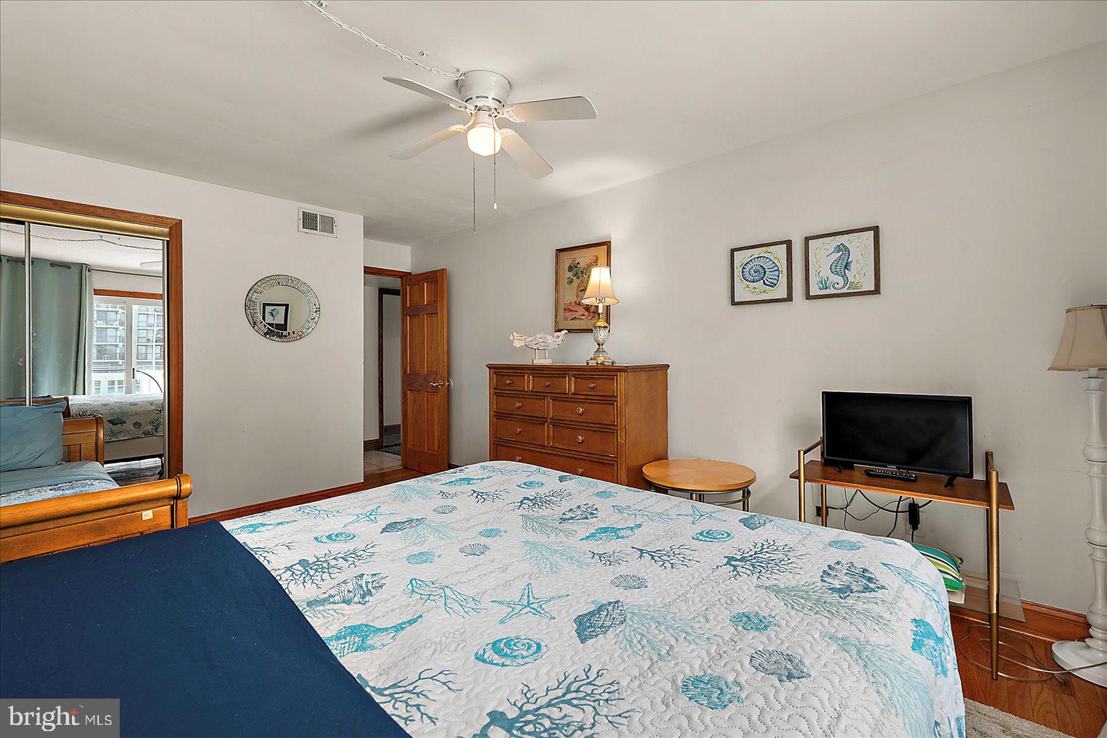 11602 Coastal Highway, Unit 1A Ocean City, MD 21842 - Photo 33 of 83 a bedroom with a bed and a flat screen tv