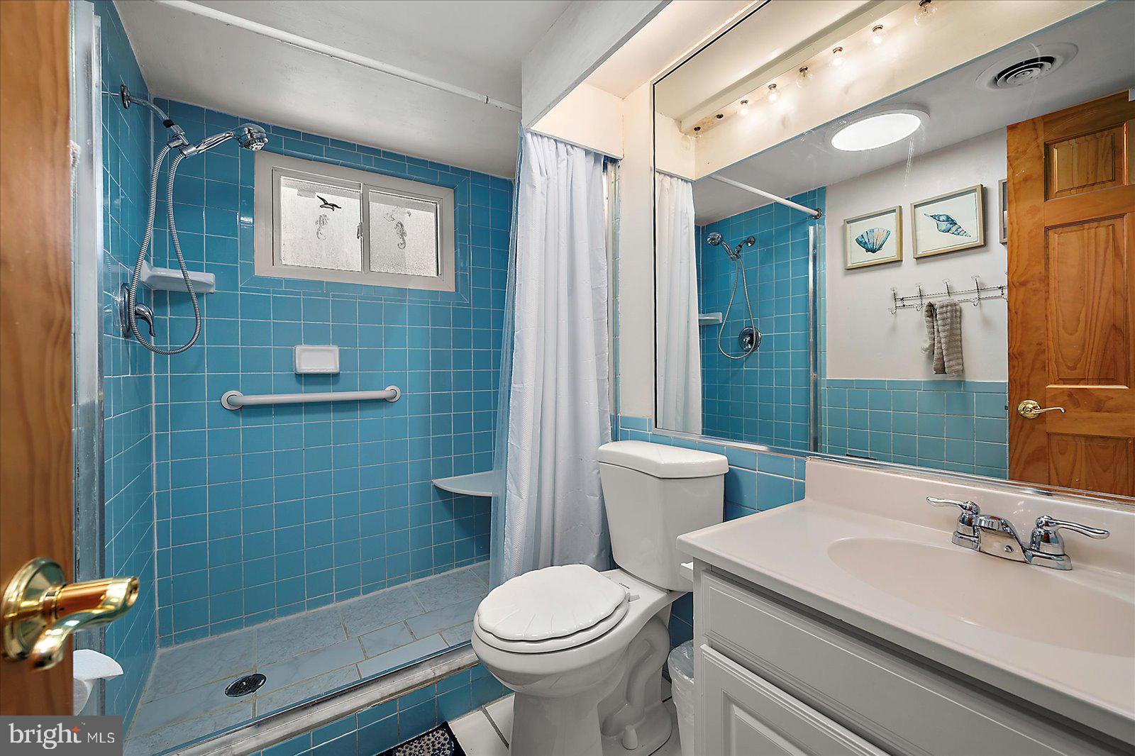 11602 Coastal Highway, Unit 1A Ocean City, MD 21842 - Photo 34 of 83 a bathroom with a sink toilet and shower