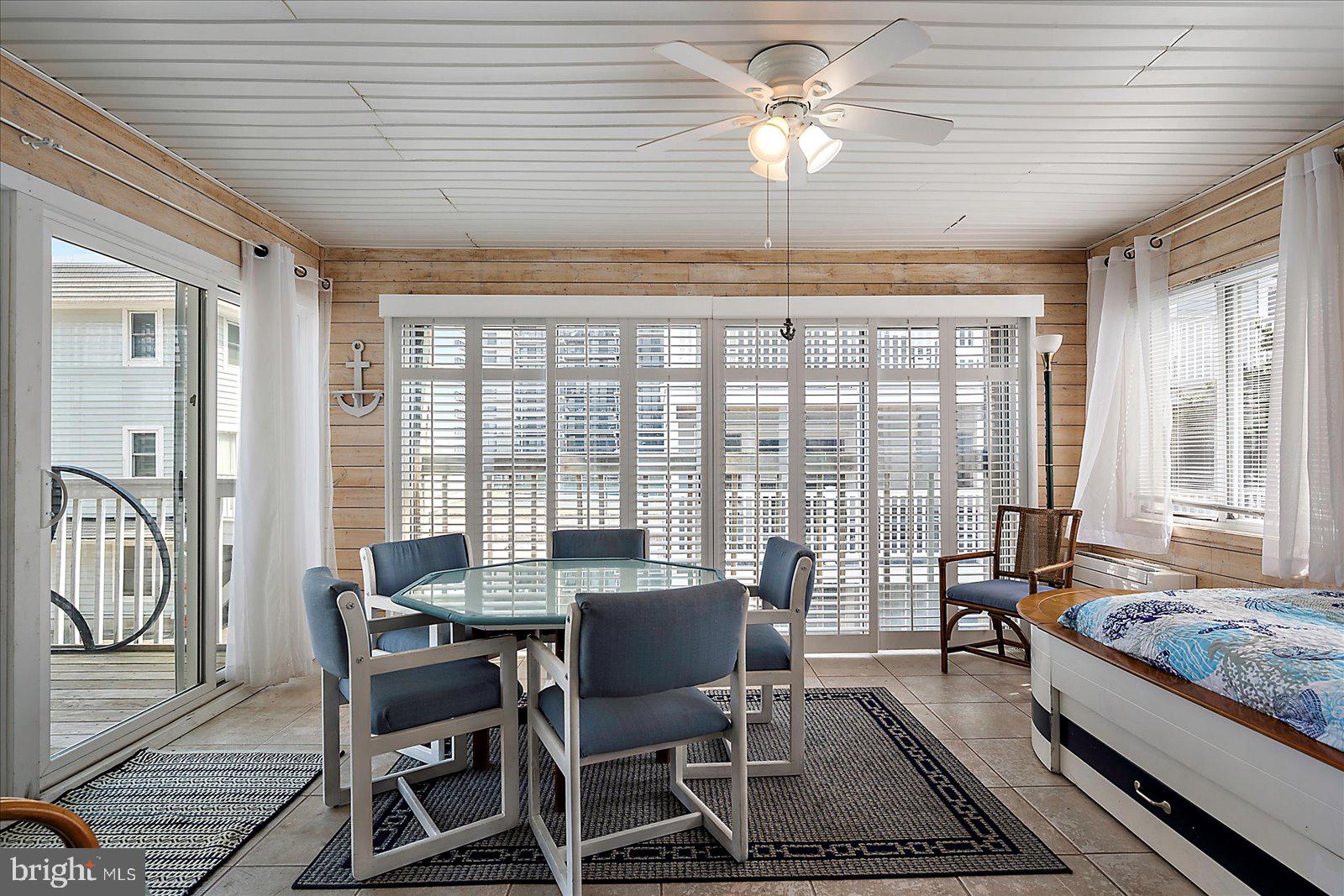 11602 Coastal Highway, Unit 1A Ocean City, MD 21842 - Photo 35 of 83 a view of a dining room with furniture a chandelier and wooden floor