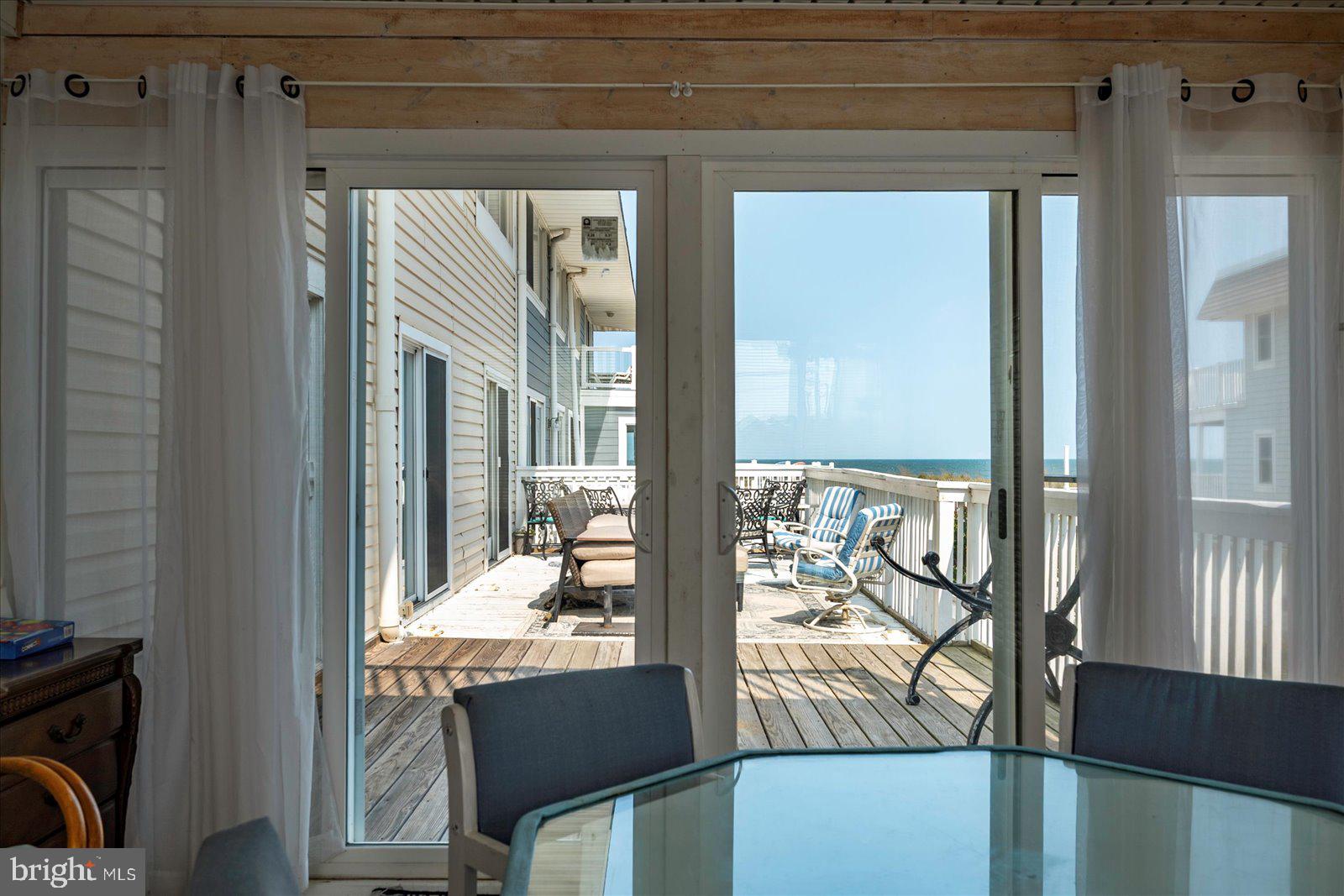 11602 Coastal Highway, Unit 1A Ocean City, MD 21842 - Photo 38 of 83 a room with furniture and large windows