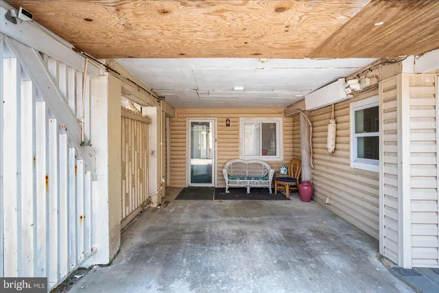 a view of a room with furniture and a window