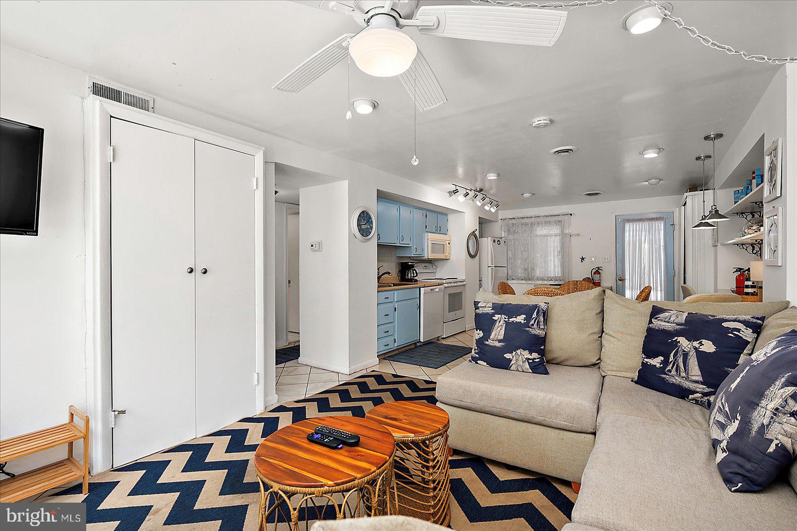 11602 Coastal Highway, Unit 1A Ocean City, MD 21842 - Photo 59 of 83 a living room with furniture and a chandelier