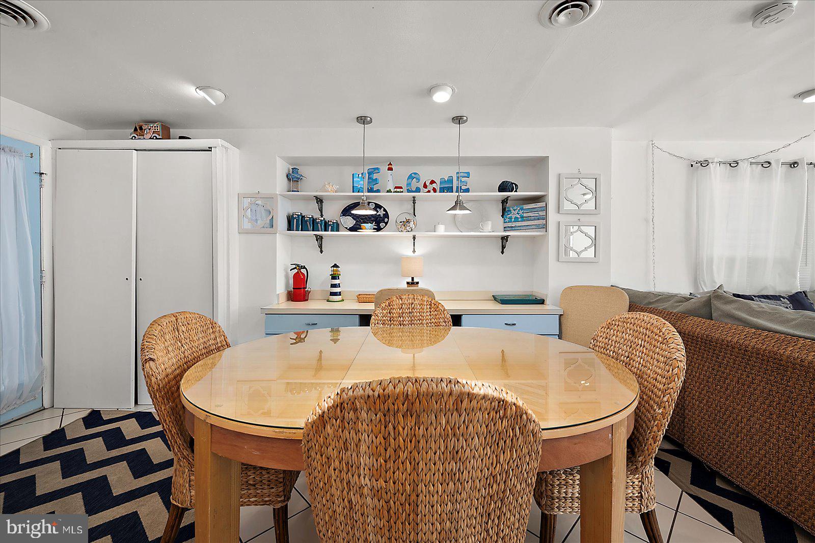 11602 Coastal Highway, Unit 1A Ocean City, MD 21842 - Photo 66 of 83 a dining room with furniture a window and a kitchen view