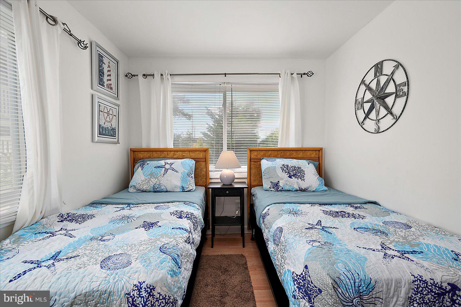 11602 Coastal Highway, Unit 1A Ocean City, MD 21842 - Photo 73 of 83 a bedroom with two beds and a large window