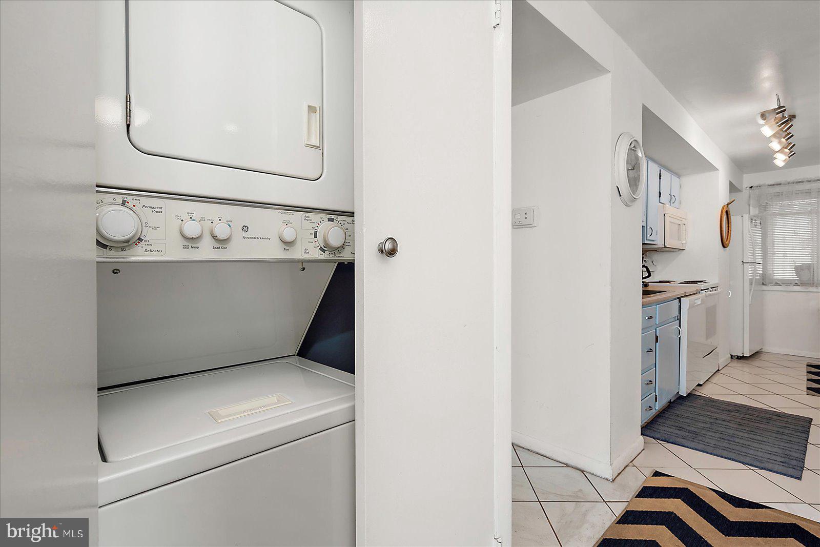 11602 Coastal Highway, Unit 1A Ocean City, MD 21842 - Photo 75 of 83 a view of washer and dryer with kitchen in the background