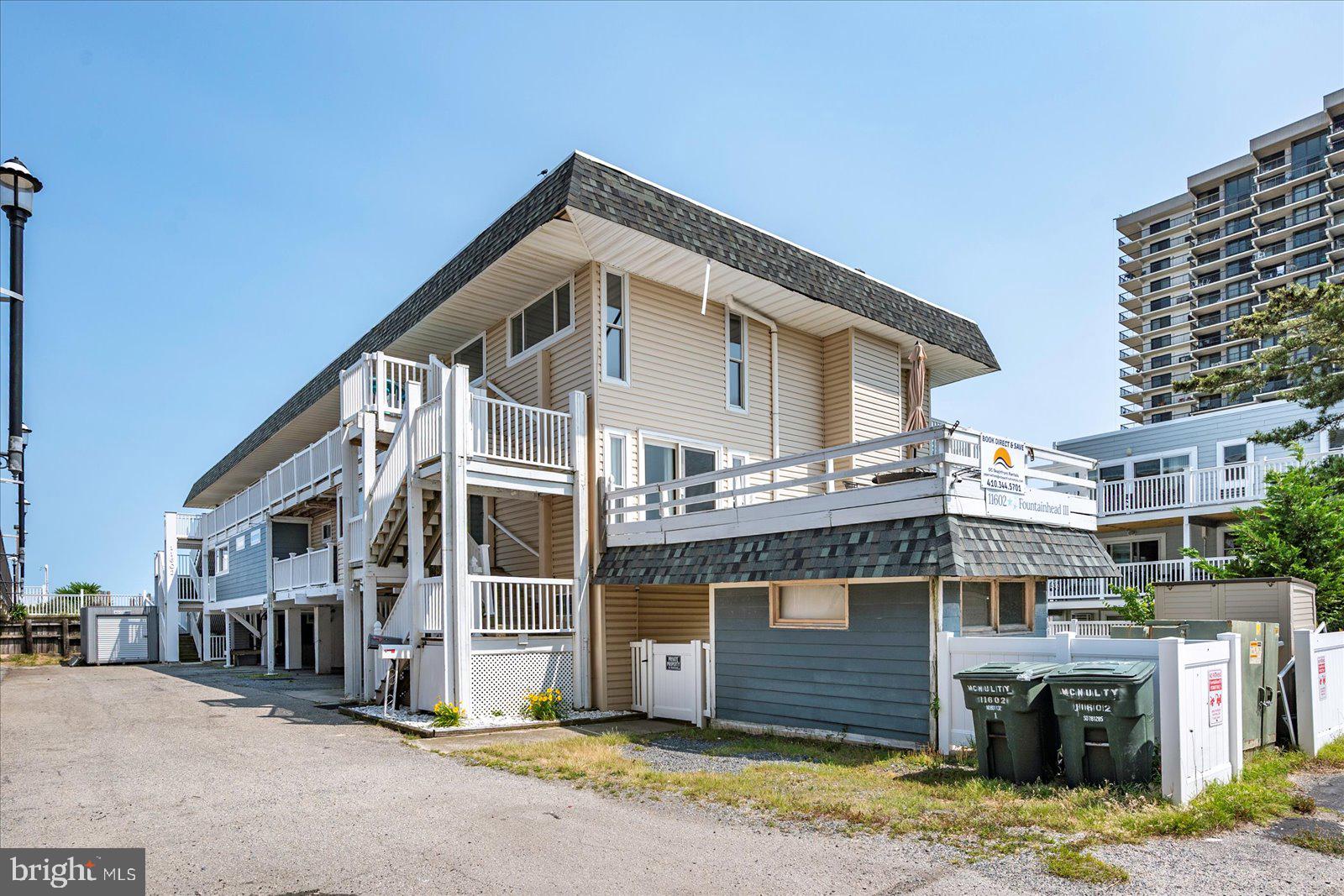 11602 Coastal Highway, Unit 1A Ocean City, MD 21842 - Photo 82 of 83 a front view of a house with a yard