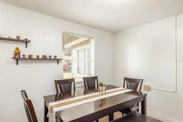 a view of a dining room with furniture and window
