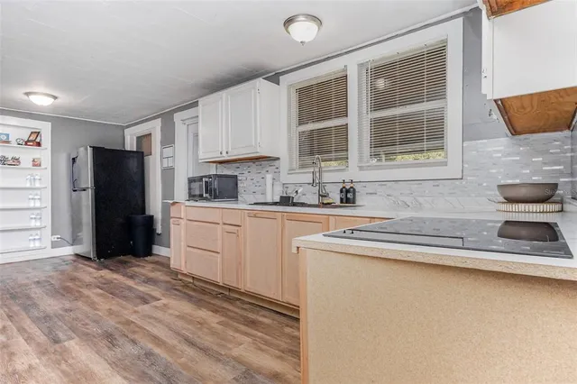 a kitchen with stainless steel appliances granite countertop a refrigerator sink and cabinets