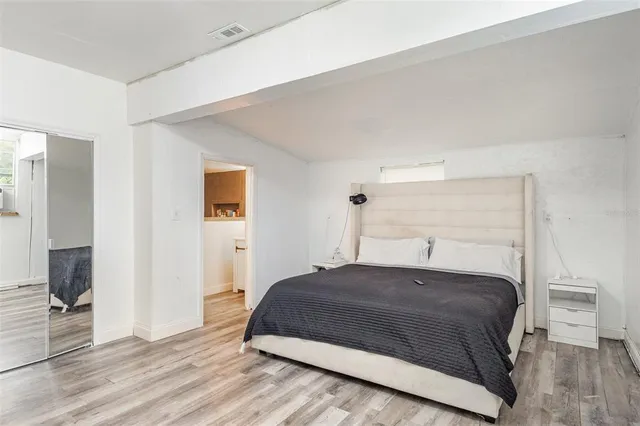 a bedroom with a bed lamp and window