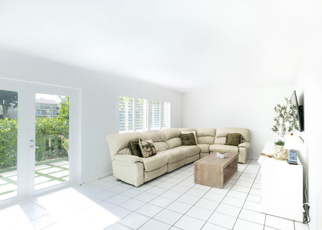 18157 Southeast Fairview Circle Jupiter, FL 33469 - Photo 16 of 27 a living room with furniture and a floor to ceiling window