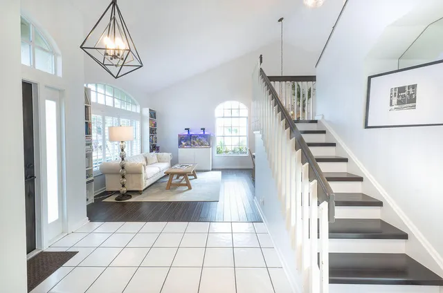 a living room with furniture and a chandelier