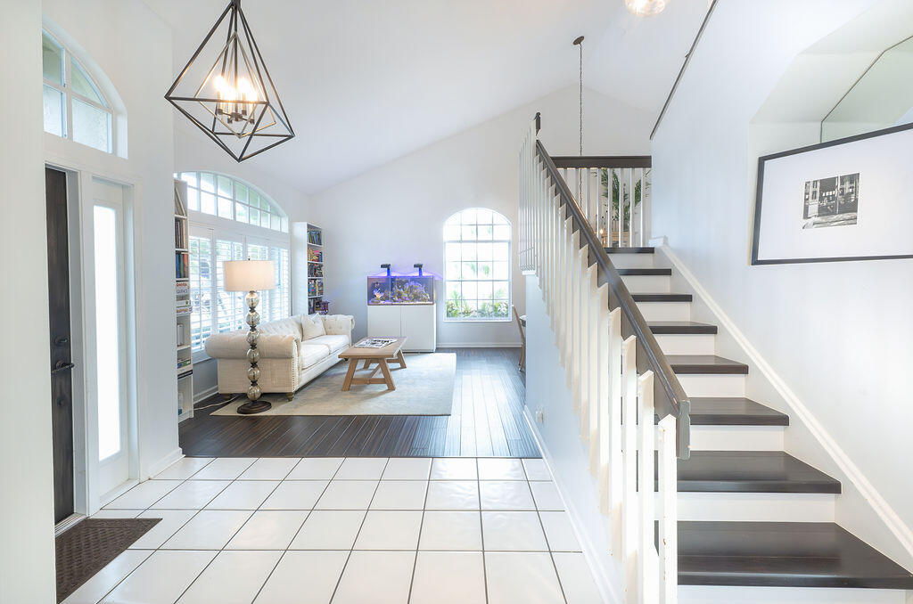 18157 Southeast Fairview Circle Jupiter, FL 33469 - Photo 10 of 27 a living room with furniture and a chandelier