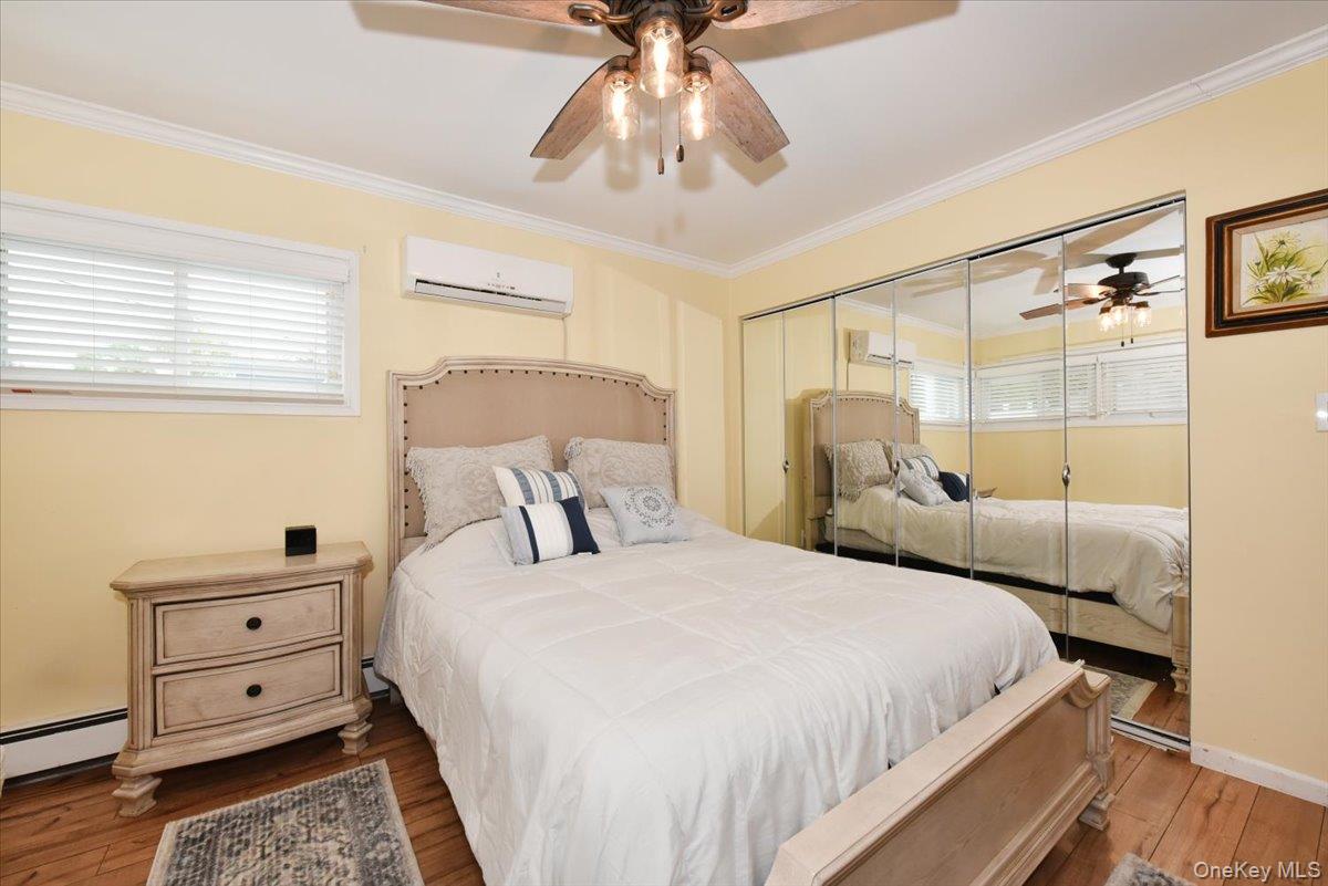 307 Blacksmith Road Levittown, NY 11756 - Photo 15 of 27 a bedroom with a bed and a chandelier