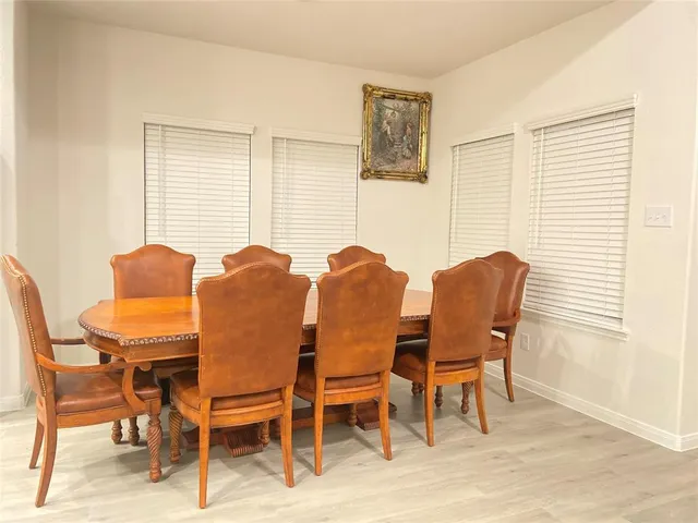 a view of a dining room with furniture and a window
