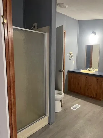 a bathroom with a toilet a sink and mirror