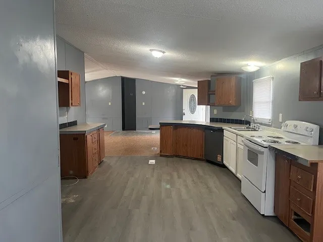 a large kitchen with a stove sink and cabinets