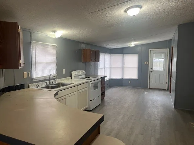 a kitchen with sink refrigerator and window