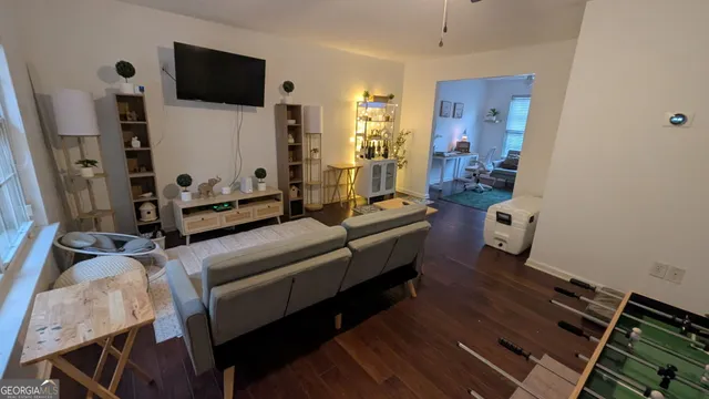 a living room with furniture a flat screen tv and a fireplace