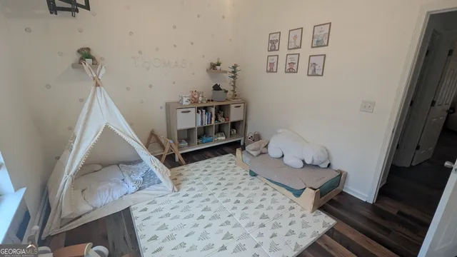 a bed sitting in a bedroom next to a window