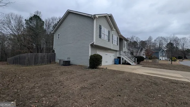 a view of backyard with wooden fence