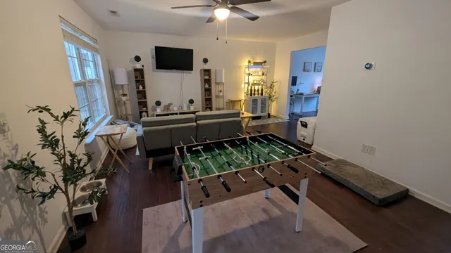 a view of deck with furniture and trees in the background