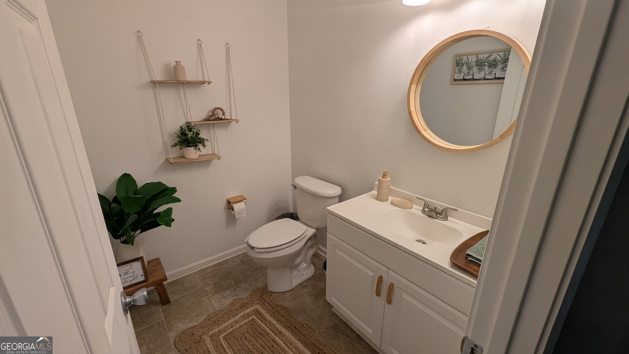 48 Highlander Trail Southwest Rome, GA 30165 - Photo 40 of 45 a bathroom with a toilet a sink and a mirror