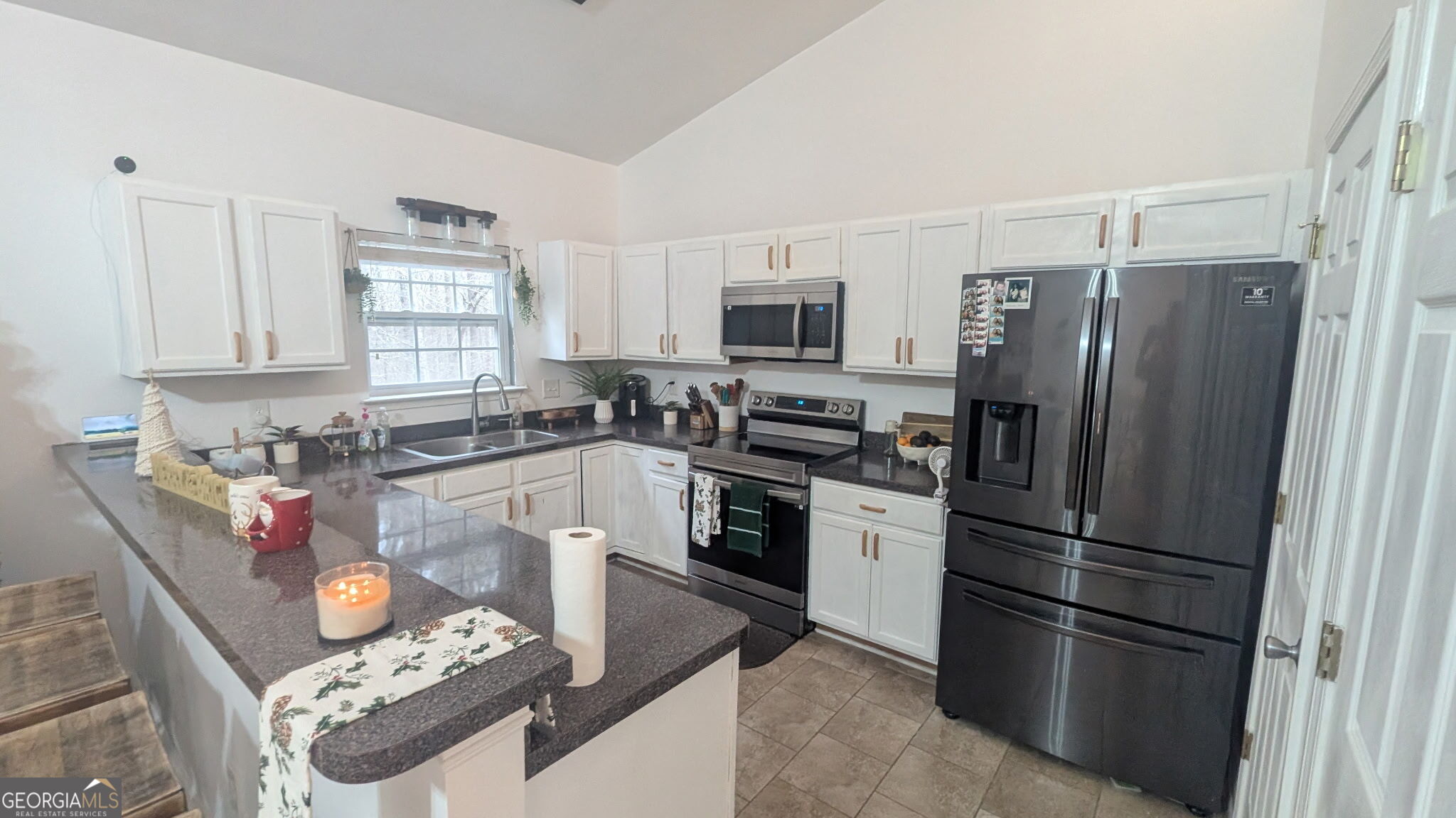 48 Highlander Trail Southwest Rome, GA 30165 - Photo 7 of 45 a kitchen with granite countertop a refrigerator stove and microwave