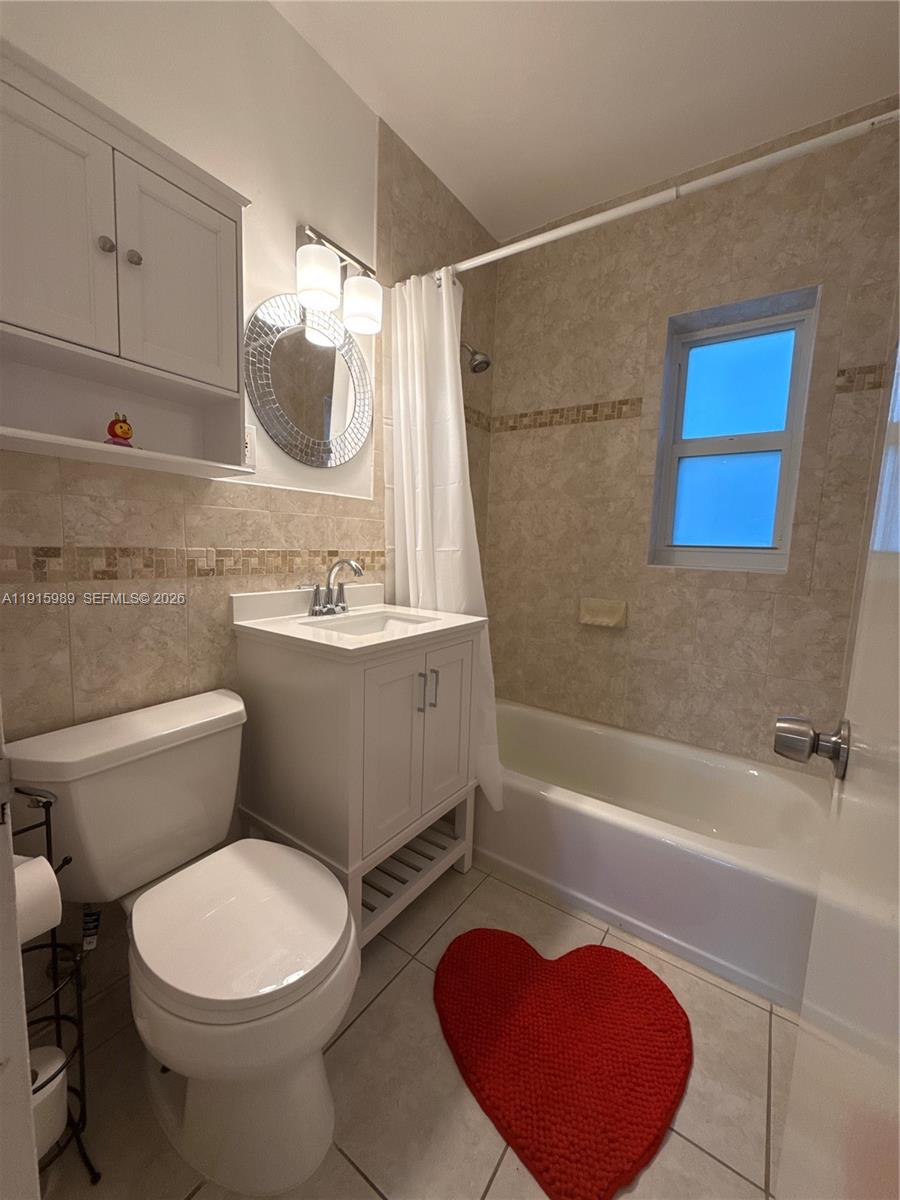 6141 Southwest 47th Street, Unit 1 Miami, FL 33155 - Photo 11 of 11 a bathroom with a sink a toilet and bathtub