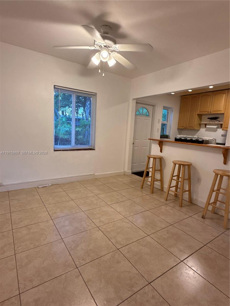 6141 Southwest 47th Street, Unit 1 Miami, FL 33155 - Photo 5 of 11 a view of a livingroom with furniture a ceiling fan and window