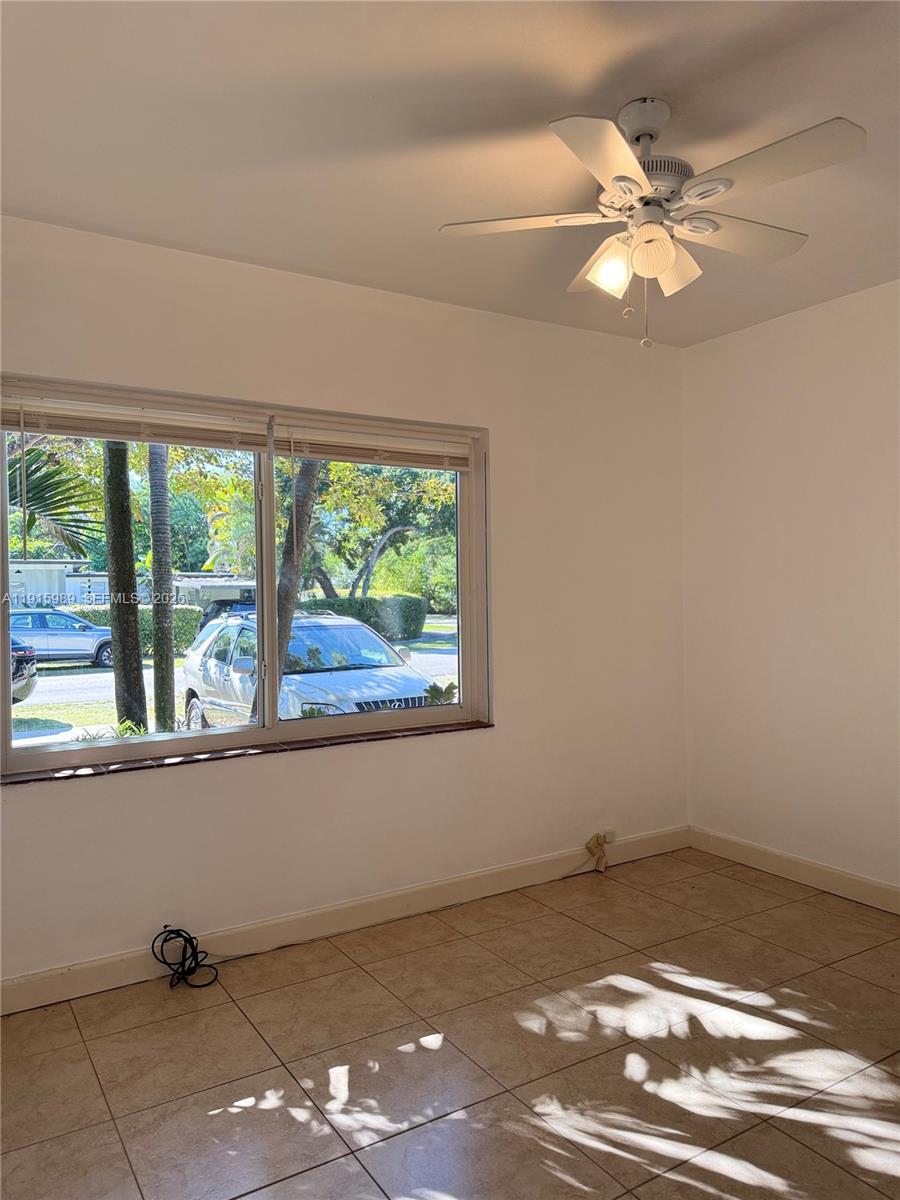 6141 Southwest 47th Street, Unit 1 Miami, FL 33155 - Photo 10 of 11 a view of a livingroom with a ceiling fan and window