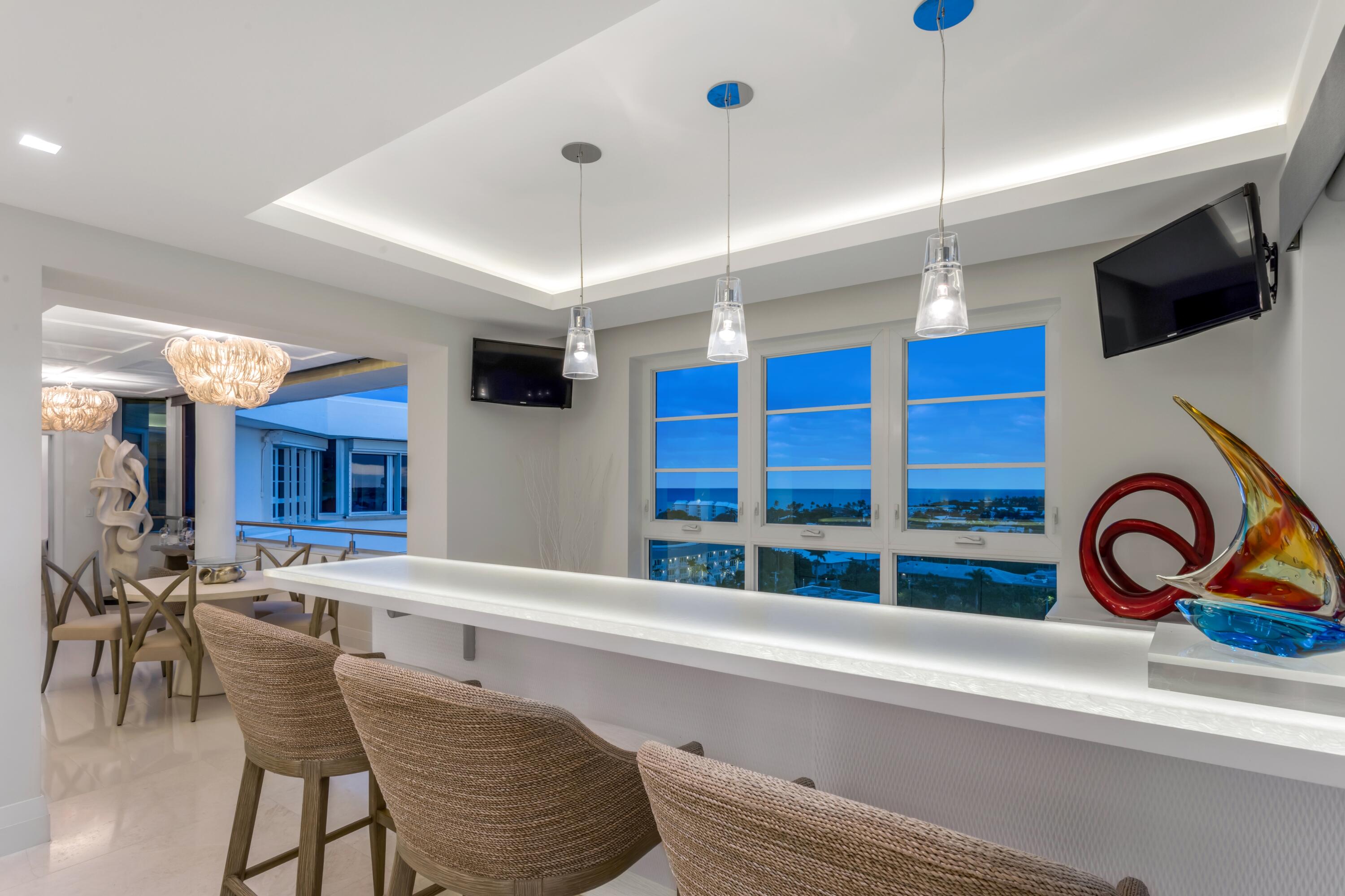 50 E Road, Unit 12G (PENTHOUSE) Delray Beach, FL 33483 - Photo 17 of 75 a kitchen with furniture a flat screen tv and a window
