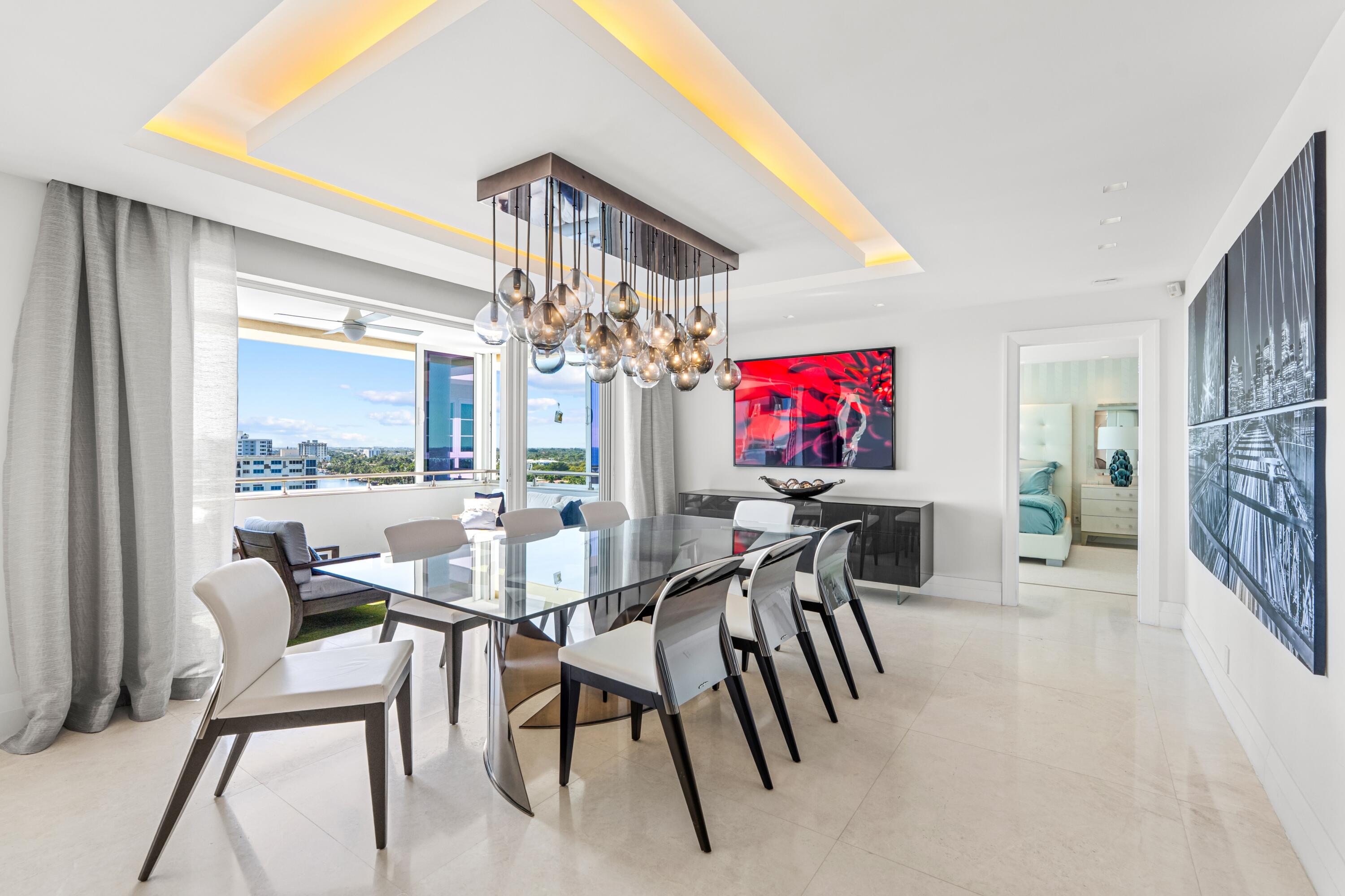 50 E Road, Unit 12G (PENTHOUSE) Delray Beach, FL 33483 - Photo 23 of 75 a dining room with furniture and a floor to ceiling window