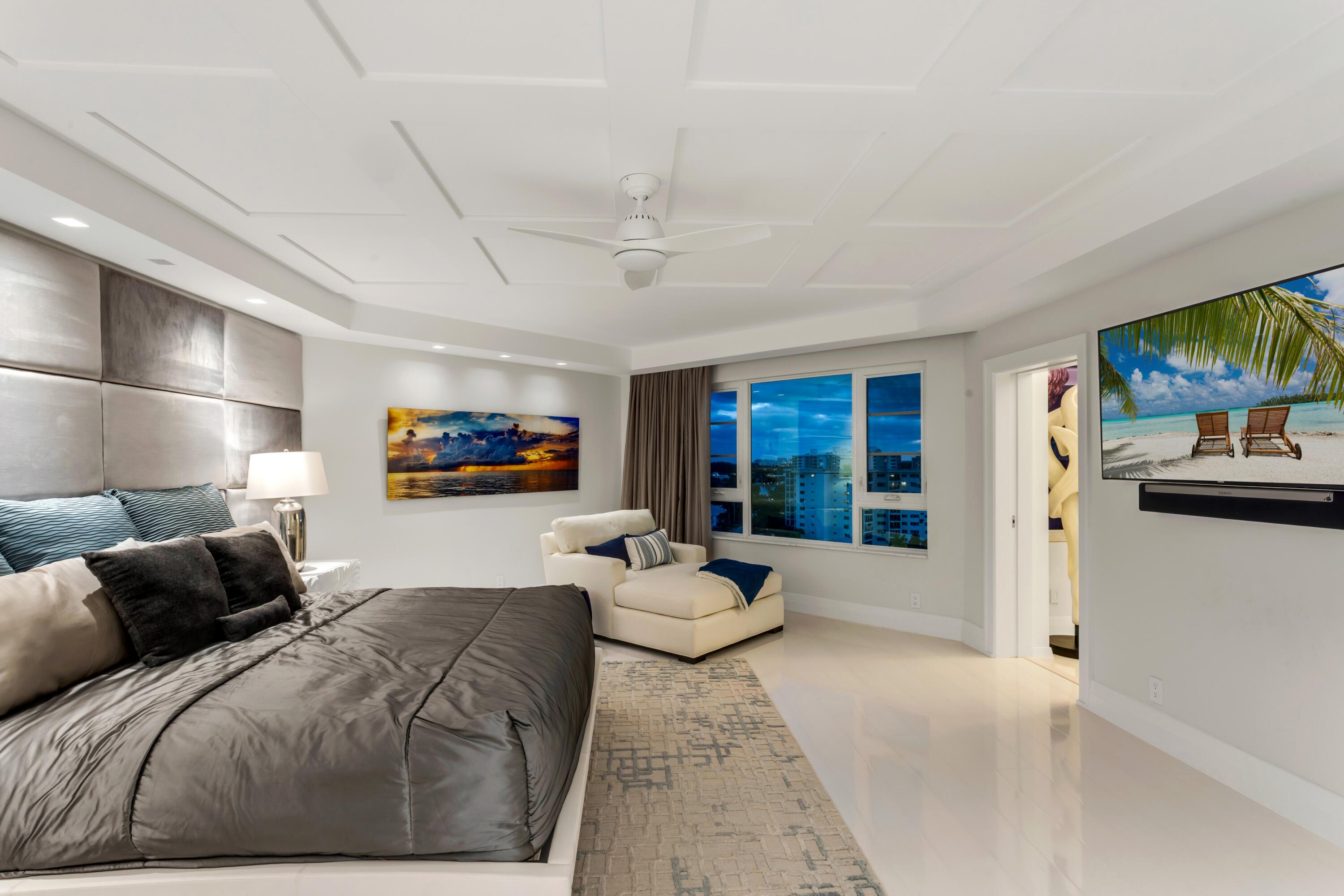 50 E Road, Unit 12G (PENTHOUSE) Delray Beach, FL 33483 - Photo 40 of 75 a bedroom with furniture a flat screen tv and a large window