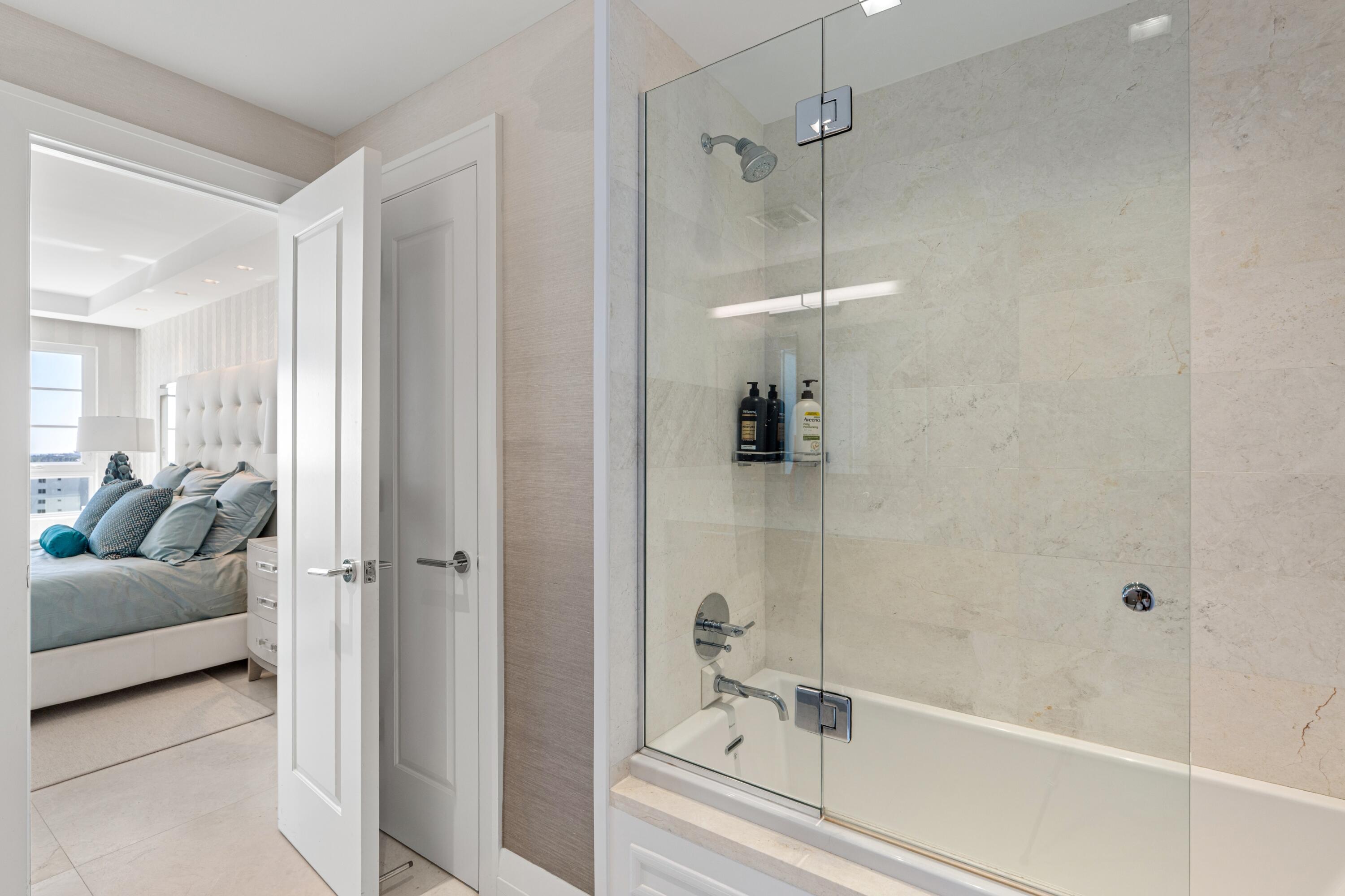 50 E Road, Unit 12G (PENTHOUSE) Delray Beach, FL 33483 - Photo 55 of 75 a bathroom with a tub and shower