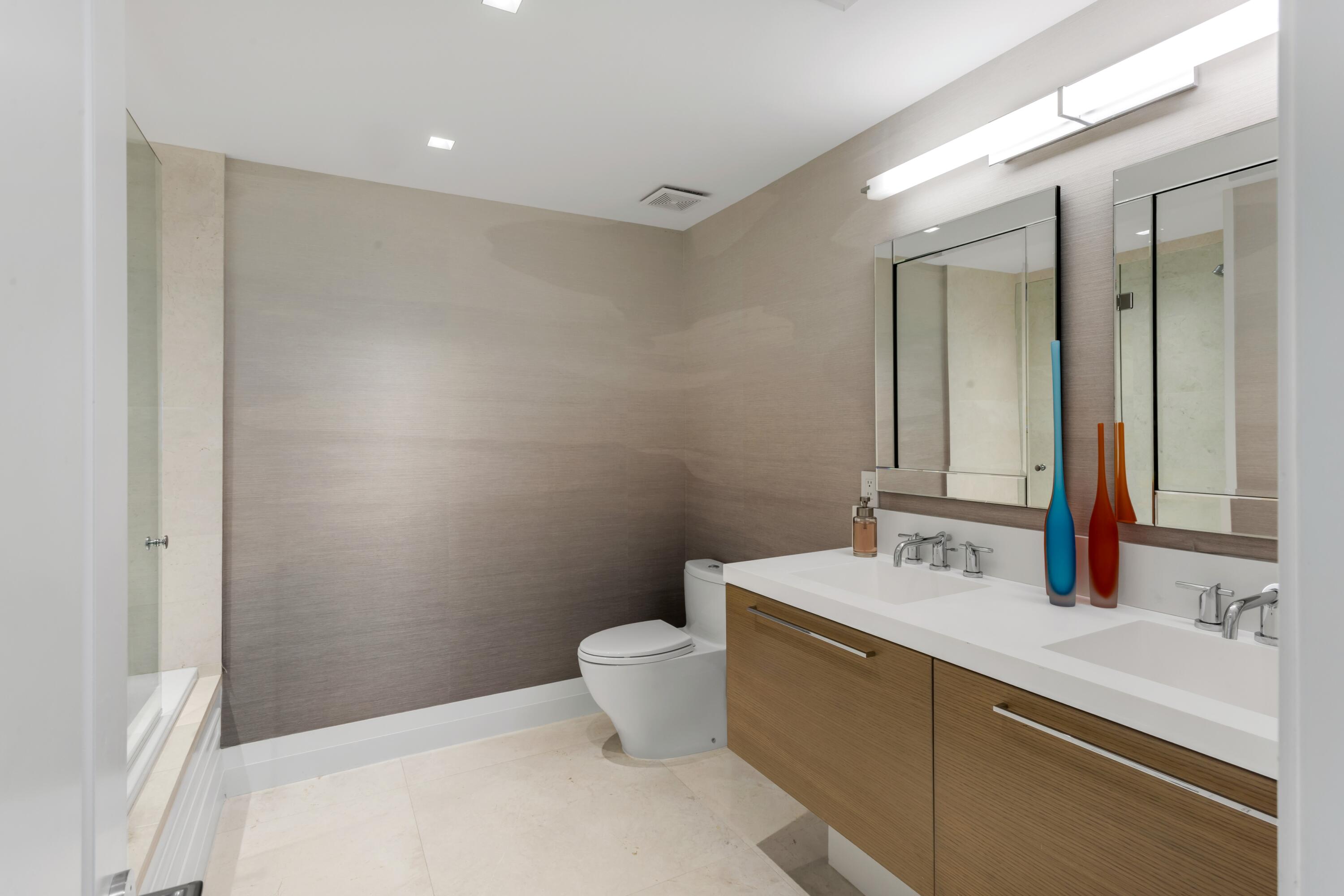 50 E Road, Unit 12G (PENTHOUSE) Delray Beach, FL 33483 - Photo 58 of 75 a bathroom with a sink mirror and toilet