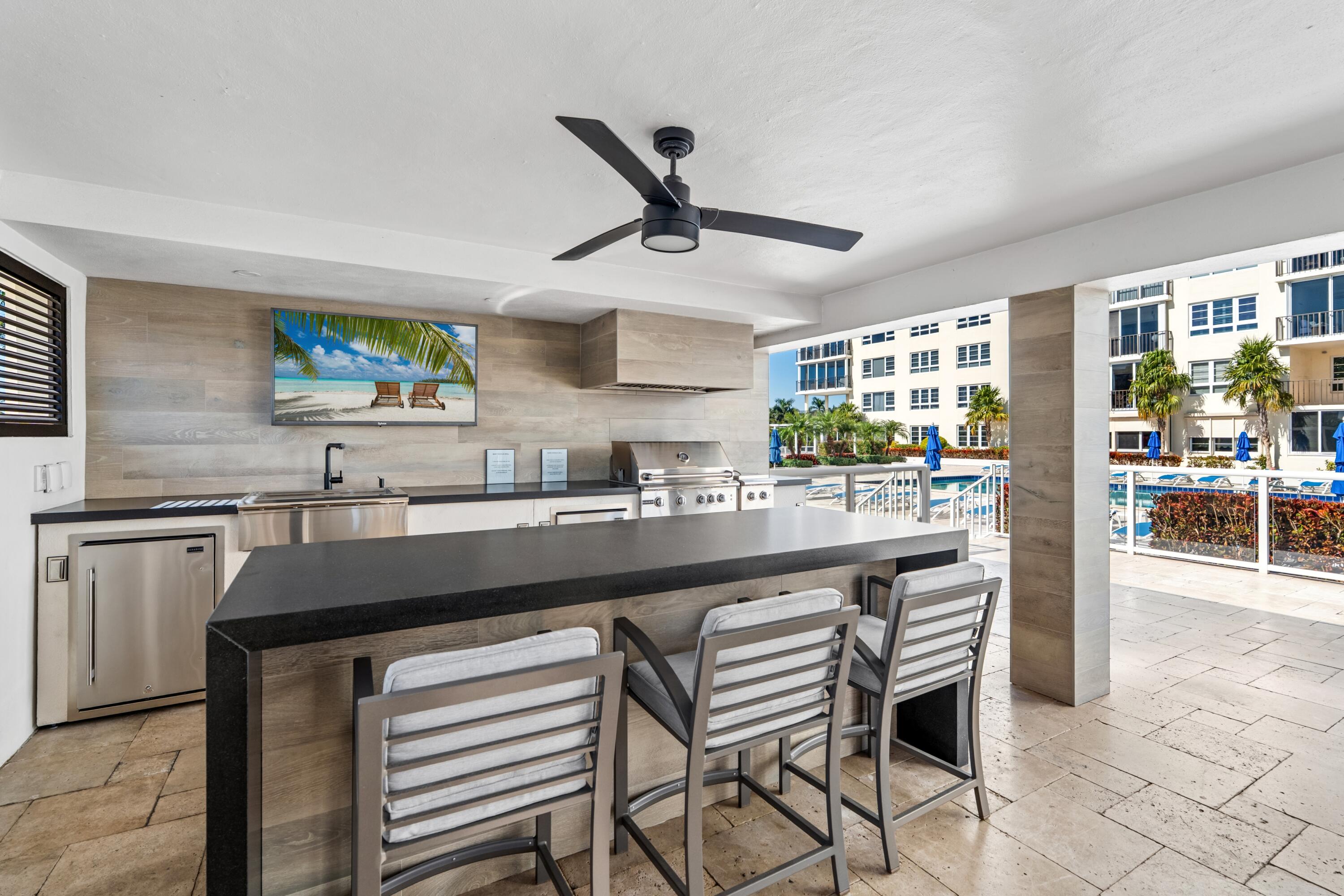 50 E Road, Unit 12G (PENTHOUSE) Delray Beach, FL 33483 - Photo 63 of 75 a kitchen with stainless steel appliances kitchen island granite countertop a sink and cabinets