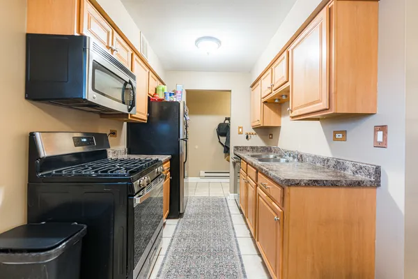 a kitchen with stainless steel appliances granite countertop a stove and a refrigerator