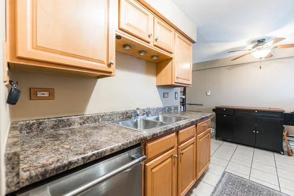 a kitchen with granite countertop a sink and cabinets