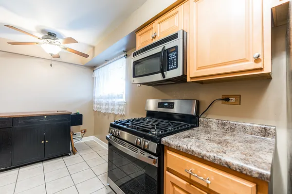 a kitchen with stainless steel appliances granite countertop a stove and a microwave