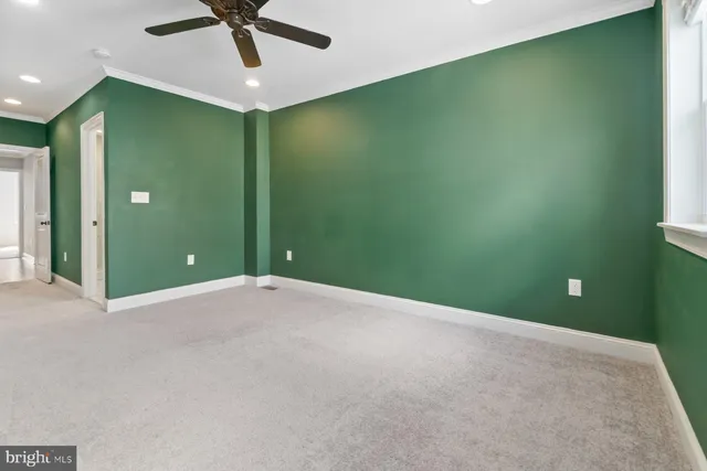 a view of a livingroom with a ceiling fan and window