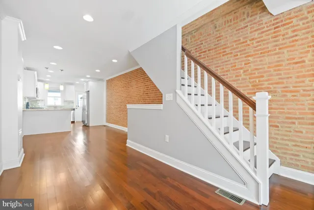 a view of an entryway with wooden floor