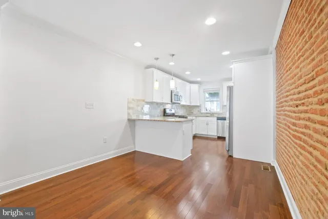 a view of kitchen with wooden floor