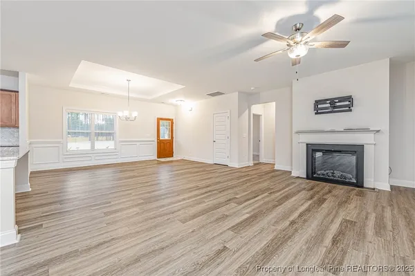a view of empty room with wooden floor and fireplace