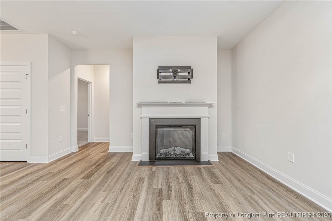 1105 Wolf Pne Court Fayetteville, NC 28311 - Photo 12 of 36 a view of a livingroom with wooden floor and a fireplace