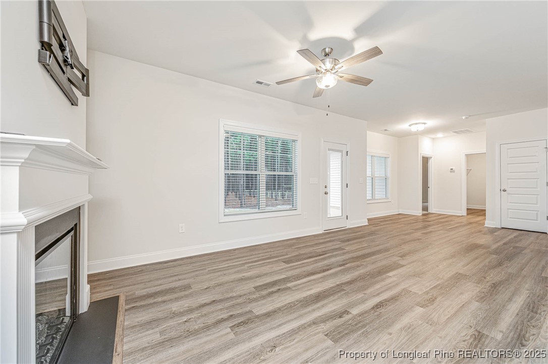1105 Wolf Pne Court Fayetteville, NC 28311 - Photo 13 of 36 a view of an empty room with wooden floor and a window
