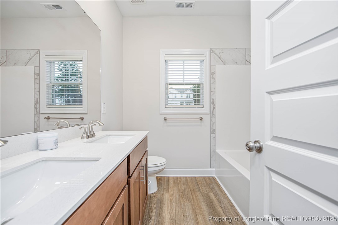 1105 Wolf Pne Court Fayetteville, NC 28311 - Photo 17 of 36 a bathroom with a sink a vanity and a window